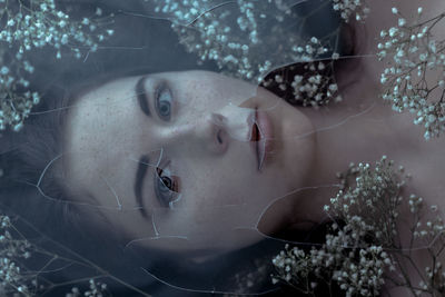Close-up of young woman with flowers