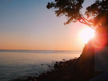 Scenic view of sea against clear sky during sunset