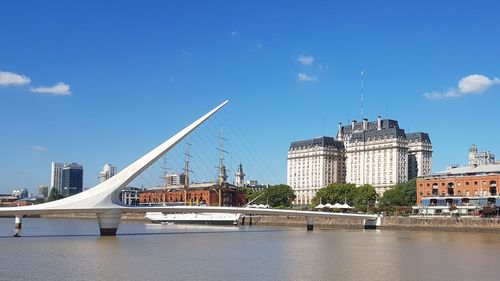 Puente de la mujer - bridge over river against buildings in buenos aires