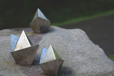 Close-up of metal ships on stone