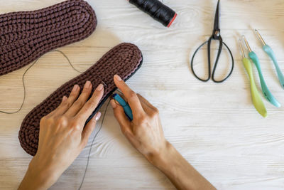 Cropped hands of woman working on table