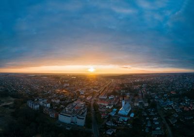 Aerial view of cityscape against sky during sunset