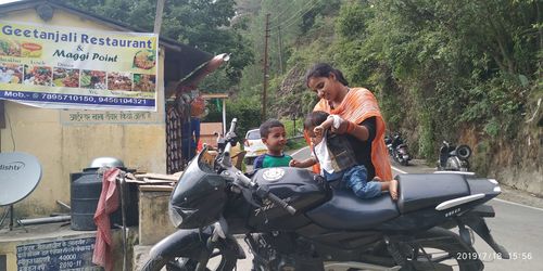 People riding motorcycle on road