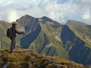 Man standing on mountain against sky