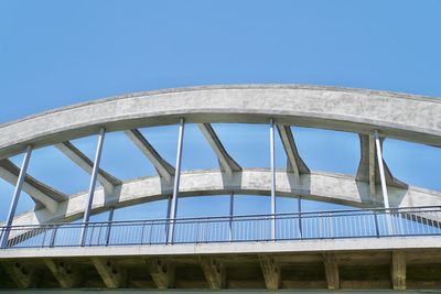 Low angle view of bridge against clear blue sky
