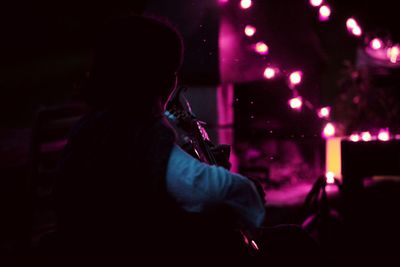 Woman using smart phone at night