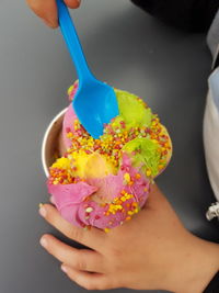 Close-up of hand holding pink flowers