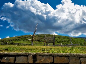 Fence on field against sky