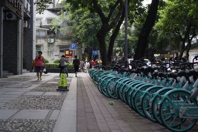 People walking on sidewalk in city