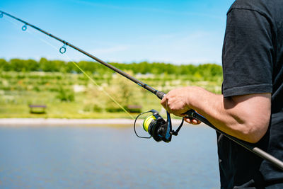 Fisherman using fishing reel