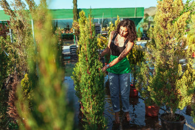 Woman standing by plants