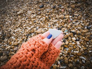 Close-up of woman hand holding ceramics at beach