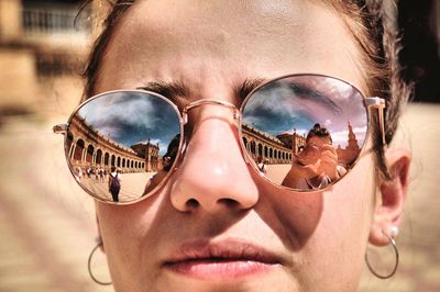 Close-up portrait of young woman wearing sunglasses