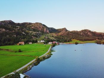 Scenic view of lake and mountains against clear sky