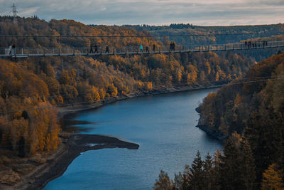 Scenic view of river amidst trees against sky