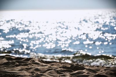 Close-up of pebbles on beach against clear sky