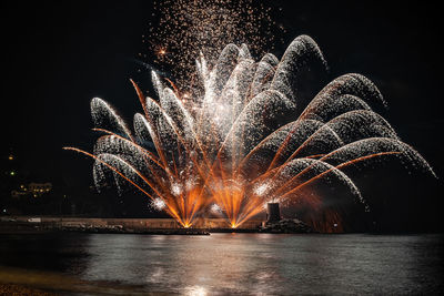 Low angle view of firework display at night