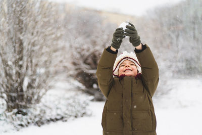 Low section of woman standing on snow