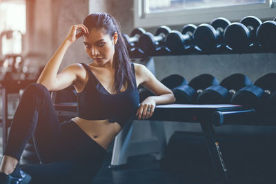 Midsection of woman sitting at home