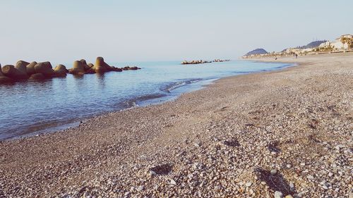 Scenic view of beach against clear sky