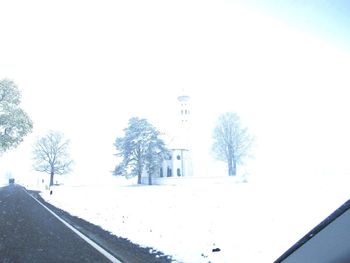 Snow covered trees against sky