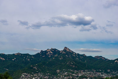 View of mountain range against cloudy sky