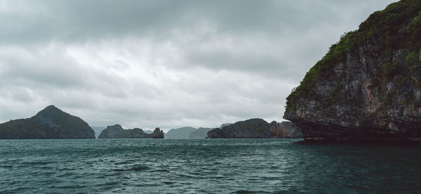 Scenic view of sea and mountains against sky