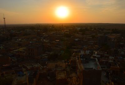 Aerial view of cityscape against sky during sunset