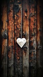 Heart on chain and wood