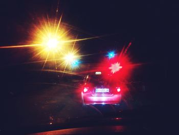 Road passing through illuminated tunnel