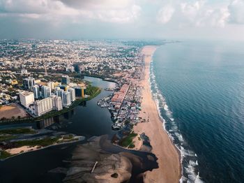 High angle view of sea and buildings against sky