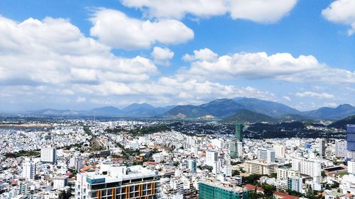 High angle view of city against cloudy sky