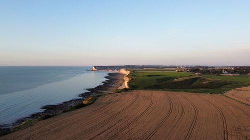 Scenic view of sea against clear sky during sunset