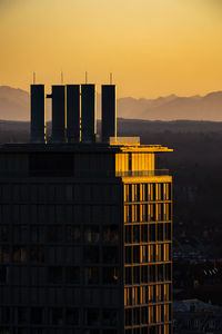 Buildings in city against sky during sunset