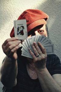 Woman poker player holding deck of cards