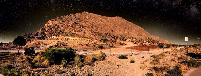 Scenic view of land against sky at night