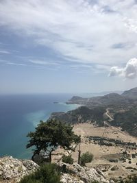 Scenic view of sea and mountains against sky