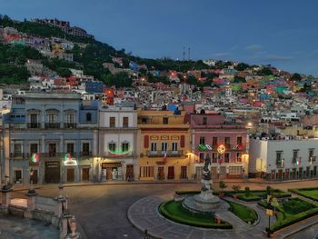 High angle view of buildings in town against sky