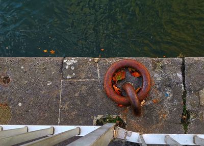 High angle view of rusty chain on lake