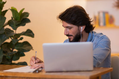 Young business man working with laptop. gray notebook for working. home office . 