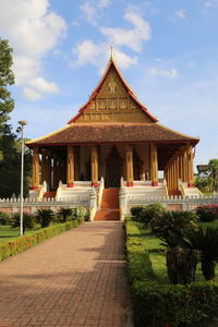 Temple by building against sky