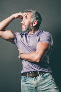 Midsection of man looking away against black background