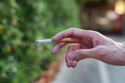 Hand holding cigarette