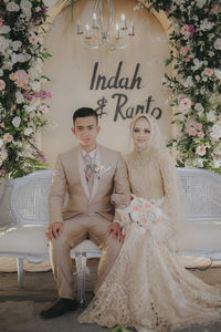 Portrait of young couple sitting outdoors