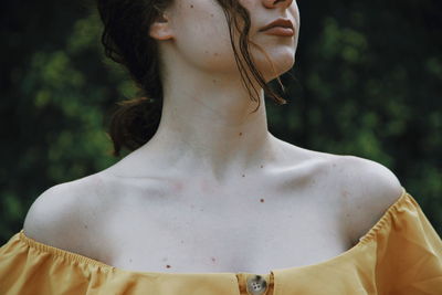 Midsection of woman standing against blurred background