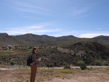 Full length of man standing on mountain against sky