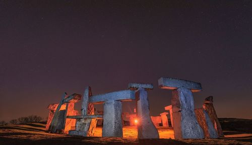 Low angle view of illuminated building against sky at night