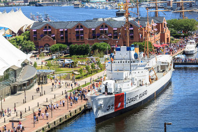 High angle view of boats in sea against buildings in city