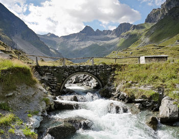 Bridge over mountains against sky