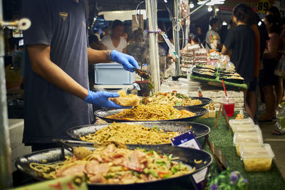 Midsection of man preparing food